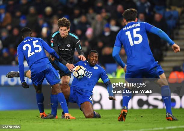 Marcos Alonso of Chelsea battles with Wilfred Ndidi and Wes Morgan of Leicester City during The Emirates FA Cup Quarter Final match between Leicester...