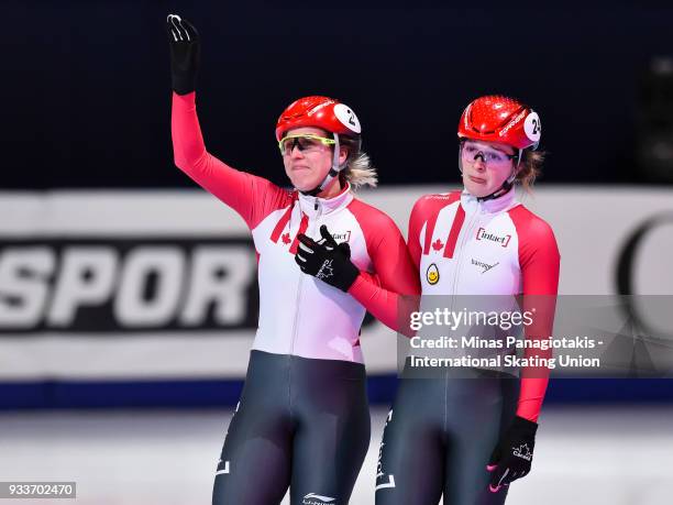 Marianne St-Gelais of Canada and Kim Boutin of Canada salute the fans in the second heat of the women's 1000 meter semifinal during the World Short...