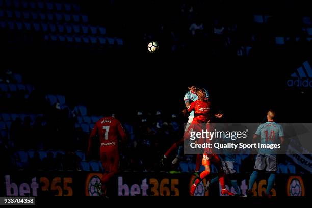 Pablo 'Tucu' Hernandez of Celta de Vigo competes for the ball with Diego Rolan of Malaga CF during the La Liga match between Celta de Vigo and Malaga...