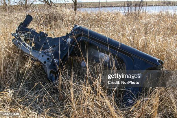 Stolen car, demounted for parts, and than cut into a few pieces , lying in the undergrowth is seen in Leszkowy, Poland on 18 March 2018 Over 10.000...