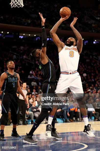 Kyle O'Quinn of the New York Knicks takes a shot against Nerlens Noel of the Dallas Mavericks in the third quarter during their game at Madison...