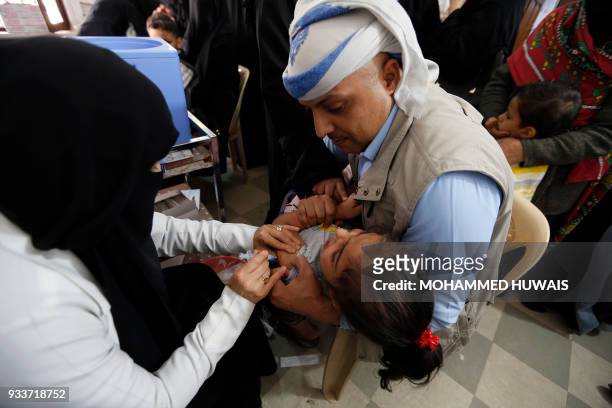 Yemeni child receives a diphtheria vaccine at a health centre in the capital Sanaa on March 18, 2018. More than 2,300 Yemenis have died of cholera...