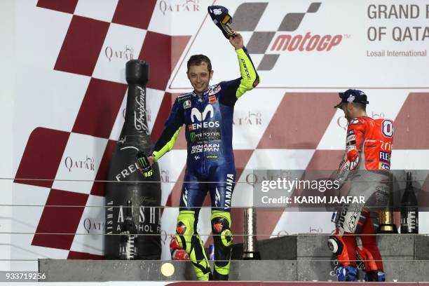 Movistar Yamaha MotoGP's Italian rider Valentino Rossi celebrates following the 2018 Qatar Moto GP Grand Prix at the Losail International Circuit in...