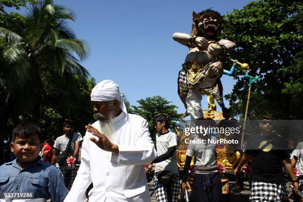 Participant carrying a giant Effigy, known as Ogoh-ogoh, during an Effigy festival at Ancol beach, North Jakarta, on Sunday, March 18, 2018. The...