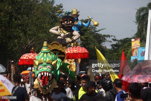 Participant carrying a giant Effigy, known as Ogoh-ogoh, during an Effigy festival at Ancol beach, North Jakarta, on Sunday, March 18, 2018. The...