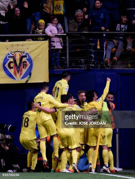 Villarreal players celebrate their second goal during the Spanish League football match between Villarreal CF and Club Atletico de Madrid at La...