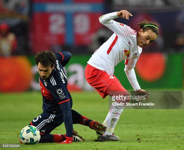 Mats Hummels of Bayern is challenged by Yussuf Poulsen of Leipzig during the Bundesliga match between RB Leipzig and FC Bayern Muenchen at Red Bull...