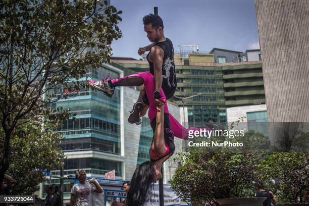 An Indonesian dancer practices pole dance at Hotel Indonesia Roundabout in Jakarta, Indonesia on March 18, 2018. In recent years many people started...