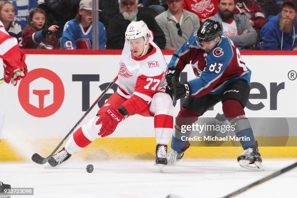Matt Nieto of the Colorado Avalanche fights for position against Evgeny Svechnikov of the Detroit Red Wings at the Pepsi Center on March 18, 2018 in...