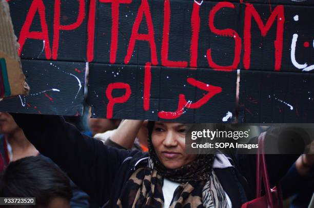 Refugee woman holds a placard during the international day against fascism. Anti-racist, anti-fascist, anti-fascist, non-parliamentary and non-racist...