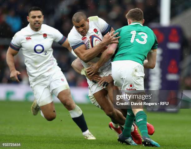 Jonathan Joseph of England is tackled by Garry Ringrose and CJ Stander during the NatWest Six Nations match between England and Ireland at Twickenham...