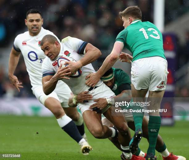 Jonathan Joseph of England is tackled by Garry Ringrose and CJ Stander during the NatWest Six Nations match between England and Ireland at Twickenham...