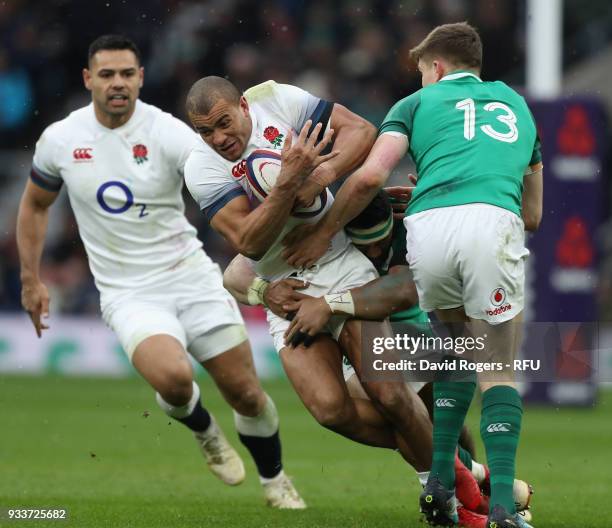 Jonathan Joseph of England is tackled by Garry Ringrose and CJ Stander during the NatWest Six Nations match between England and Ireland at Twickenham...
