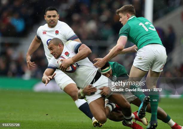 Jonathan Joseph of England is tackled by Garry Ringrose and CJ Stander during the NatWest Six Nations match between England and Ireland at Twickenham...
