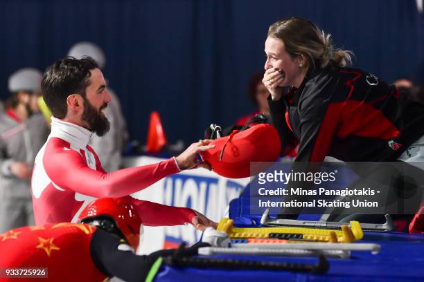 Charles Hamelin of Canada celebrates with Marianne St-Gelais of Canada after becoming the overall champion in the men's 3000 meter SuperFinal during...