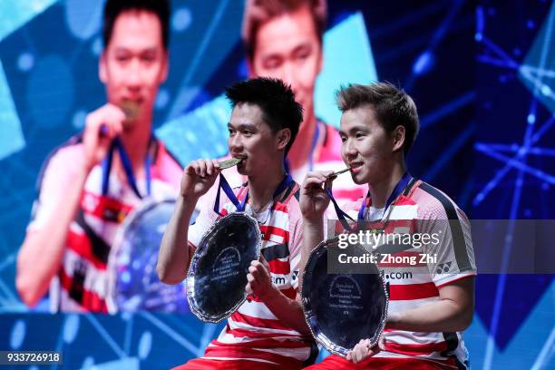 Marcus Fernaldi Gideon of Indonesia and Kevin Sanjaya Sukamuljo of Indonesia celebrate with the trophy after winning over Mathias Boe of Denmark and...