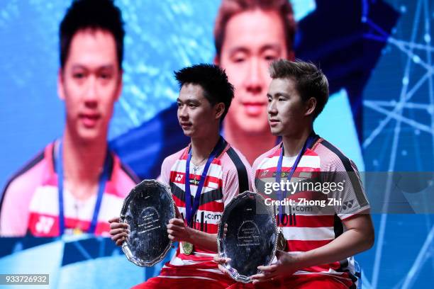 Marcus Fernaldi Gideon of Indonesia and Kevin Sanjaya Sukamuljo of Indonesia celebrate with the trophy after winning over Mathias Boe of Denmark and...