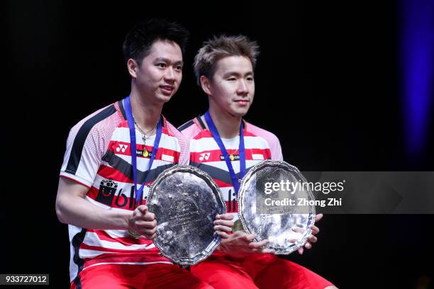 Marcus Fernaldi Gideon of Indonesia and Kevin Sanjaya Sukamuljo of Indonesia celebrate with the trophy after winning over Mathias Boe of Denmark and...