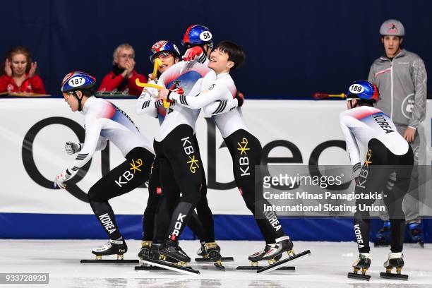 Members of team Korea celebrate after placing first in the men's 5000 meter relay Final during the World Short Track Speed Skating Championships at...