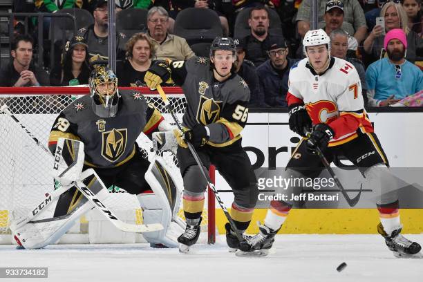 Erik Haula and goalie Marc-Andre Fleury of the Vegas Golden Knights defend their goal against T.J. Brodie of the Calgary Flames during the game at...