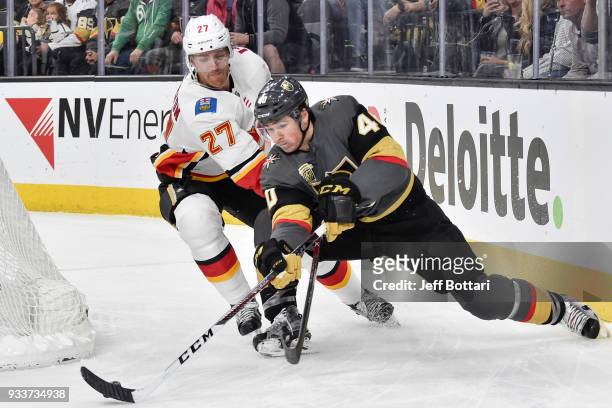 Ryan Carpenter of the Vegas Golden Knights skates with the puck while Dougie Hamilton of the Calgary Flames defends during the game at T-Mobile Arena...