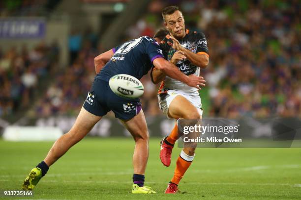 Luke Brooks of the Tigers is tackled during the round two NRL match between the Melbourne Storm and the Wests Tigers at AAMI Park on March 17, 2018...