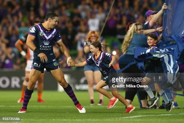 Billy Slater walks out with his two children, daughter Tyla Rose and son Jake for this 300th match during the round two NRL match between the...