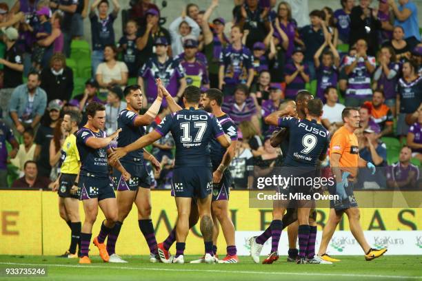 Melbourne Storm players celebrate a try during the round two NRL match between the Melbourne Storm and the Wests Tigers at AAMI Park on March 17,...