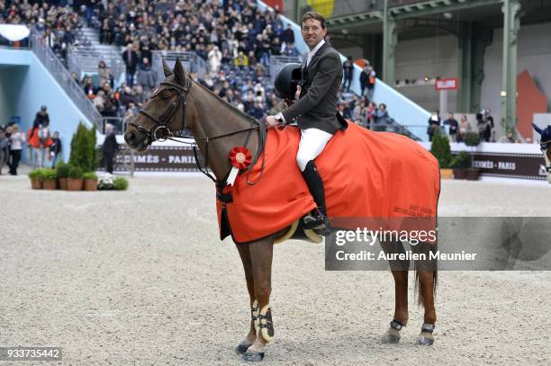 Simon Delestre of France on Hermes Ryan cheers with the crowd after winning the Saut Hermes at Le Grand Palais on March 18, 2018 in Paris, France.