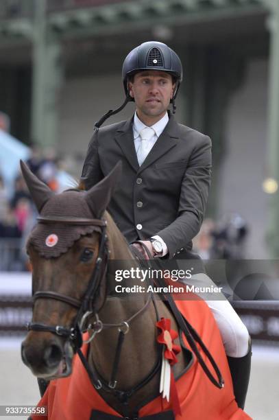 Simon Delestre of France on Hermes Ryan cheers with the crowd after winning the Saut Hermes at Le Grand Palais on March 18, 2018 in Paris, France.