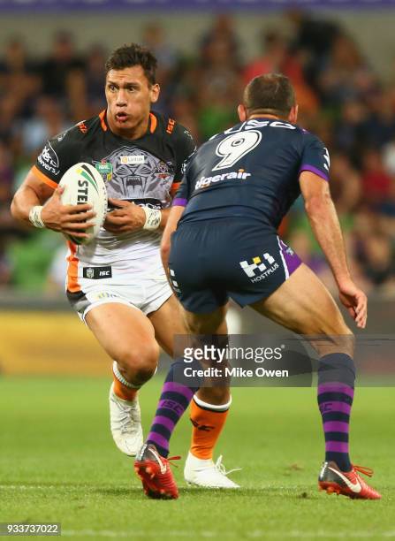 Elijah Taylor of the Tigers runs with the ball during the round two NRL match between the Melbourne Storm and the Wests Tigers at AAMI Park on March...