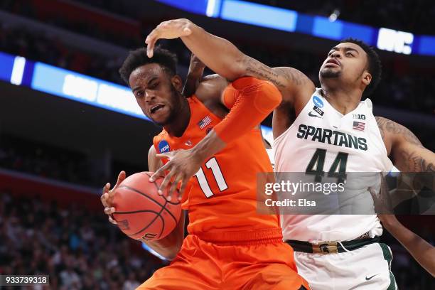 Oshae Brissett of the Syracuse Orange battles for the ball with Nick Ward of the Michigan State Spartans during the second half in the second round...