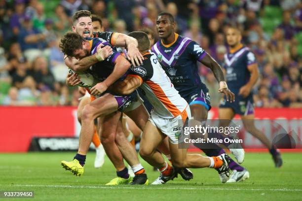 Joe Stimson os the Storm is tackled during the round two NRL match between the Melbourne Storm and the Wests Tigers at AAMI Park on March 17, 2018 in...