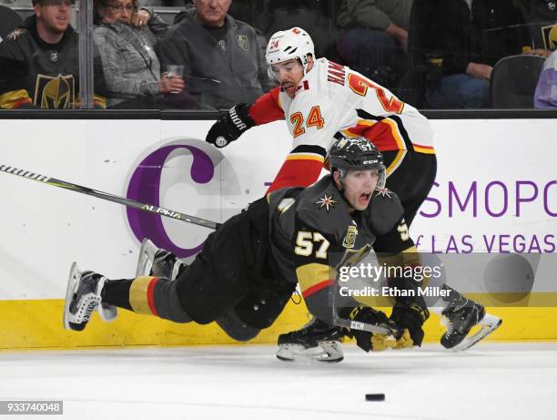 David Perron of the Vegas Golden Knights falls to the ice as he goes after the puck against Travis Hamonic of the Calgary Flames in the first period...