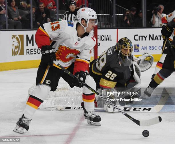 Marc-Andre Fleury of the Vegas Golden Knights tends net as Johnny Gaudreau of the Calgary Flames skates with the puck in the first period of their...