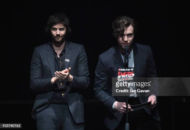 Actors Jim Sturgess and Tom Hughes present the award for Best Female Newcomer on stage during the Rakuten TV EMPIRE Awards 2018 at The Roundhouse on...