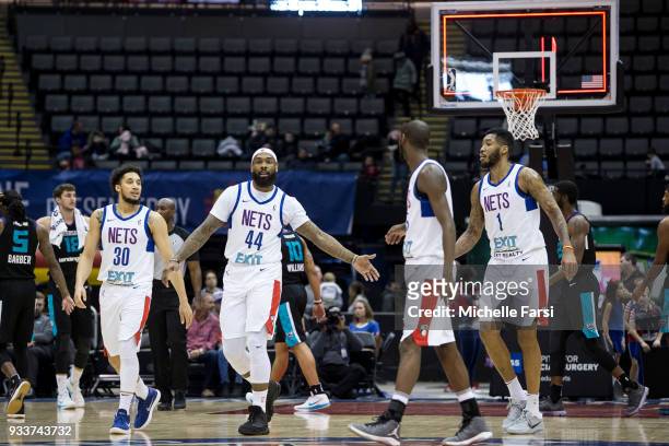 Moore of the Long Island Nets high-fives teammates during the game against the Greenboro Swarm on March 18, 2018 at NYCB Live Home of the Nassau...