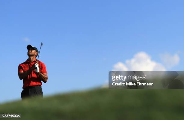 Tiger Woods plays his shot from the 14th tee during the final round at the Arnold Palmer Invitational Presented By MasterCard at Bay Hill Club and...