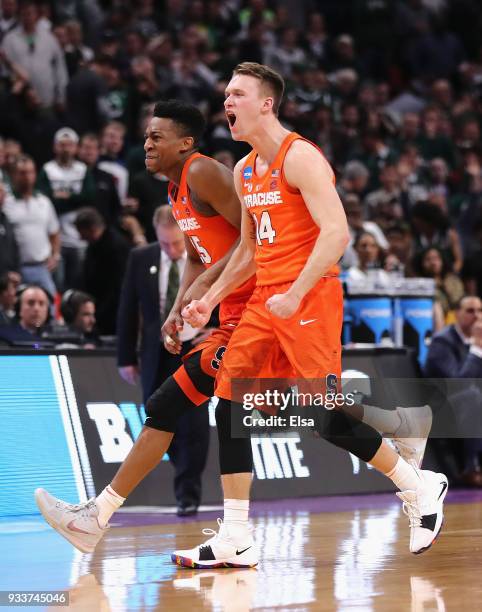 Tyus Battle of the Syracuse Orange and Braedon Bayer celebrate after defeating the Michigan State Spartans 55-53 in the second round of the 2018 NCAA...