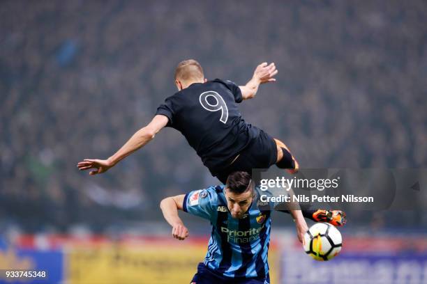 Rasmus Lindkvist of AIK is tackled by Haris Radetinac of Djurgardens IF during the Swedish Cup Semifinal between AIK and Djurgardens IF at Friends...