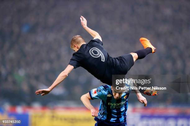 Rasmus Lindkvist of AIK is tackled by Haris Radetinac of Djurgardens IF during the Swedish Cup Semifinal between AIK and Djurgardens IF at Friends...