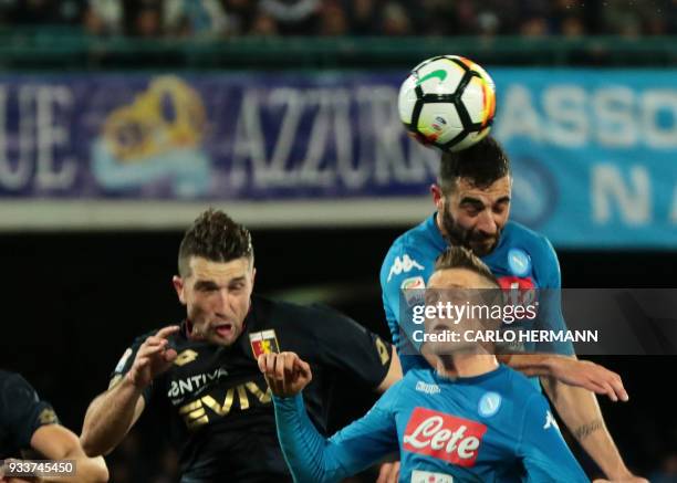 Napoli's Spanish defender Raul Albiol heads the ball and scores during the Italian Serie A football match SSC Napoli vs Genoa CFC on March 18, 2018...