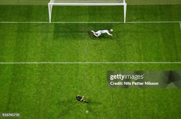 Andreas Isaksson of Djurgardens IF makes a save on a penalty shot by Tarik Elyounoussi of AIK during the Swedish Cup Semifinal between AIK and...