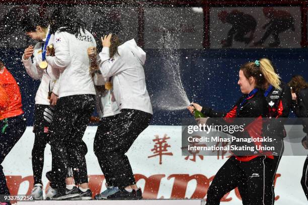 Marianne St-Gelais of Canada sprays champagne after Team Canada wins the bronze in the women's 3000 meter relay Final during the World Short Track...