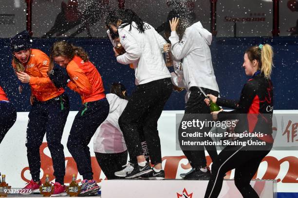 Marianne St-Gelais of Canada sprays champagne after Team Canada wins the bronze in the women's 3000 meter relay Final during the World Short Track...