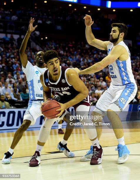 Tyler Davis of the Texas A&M Aggies drives to the basket against Luke Maye of the North Carolina Tar Heels during the second round of the 2018 NCAA...