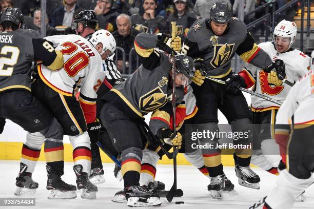 Pierre-Edouard Bellemare, Ryan Reaves and Tomas Nosek of the Vegas Golden Knights battle for the puck with Curtis Lazar and Travis Hamonic of the...