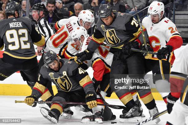 Pierre-Edouard Bellemare, Ryan Reaves and Tomas Nosek of the Vegas Golden Knights battle for the puck with Curtis Lazar, Sean Monahan and Travis...