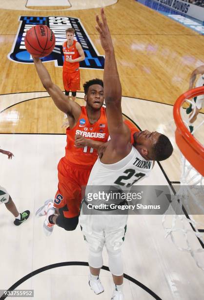 Oshae Brissett of the Syracuse Orange drives to the basket against Xavier Tillman of the Michigan State Spartans in the second round of the 2018 NCAA...