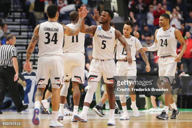 Trevor Moore of the Cincinnati Bearcats high fives Jarron Cumberland against the Nevada Wolf Pack during the first half in the second round of the...